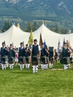Canmore highland games pipers and drummers on field